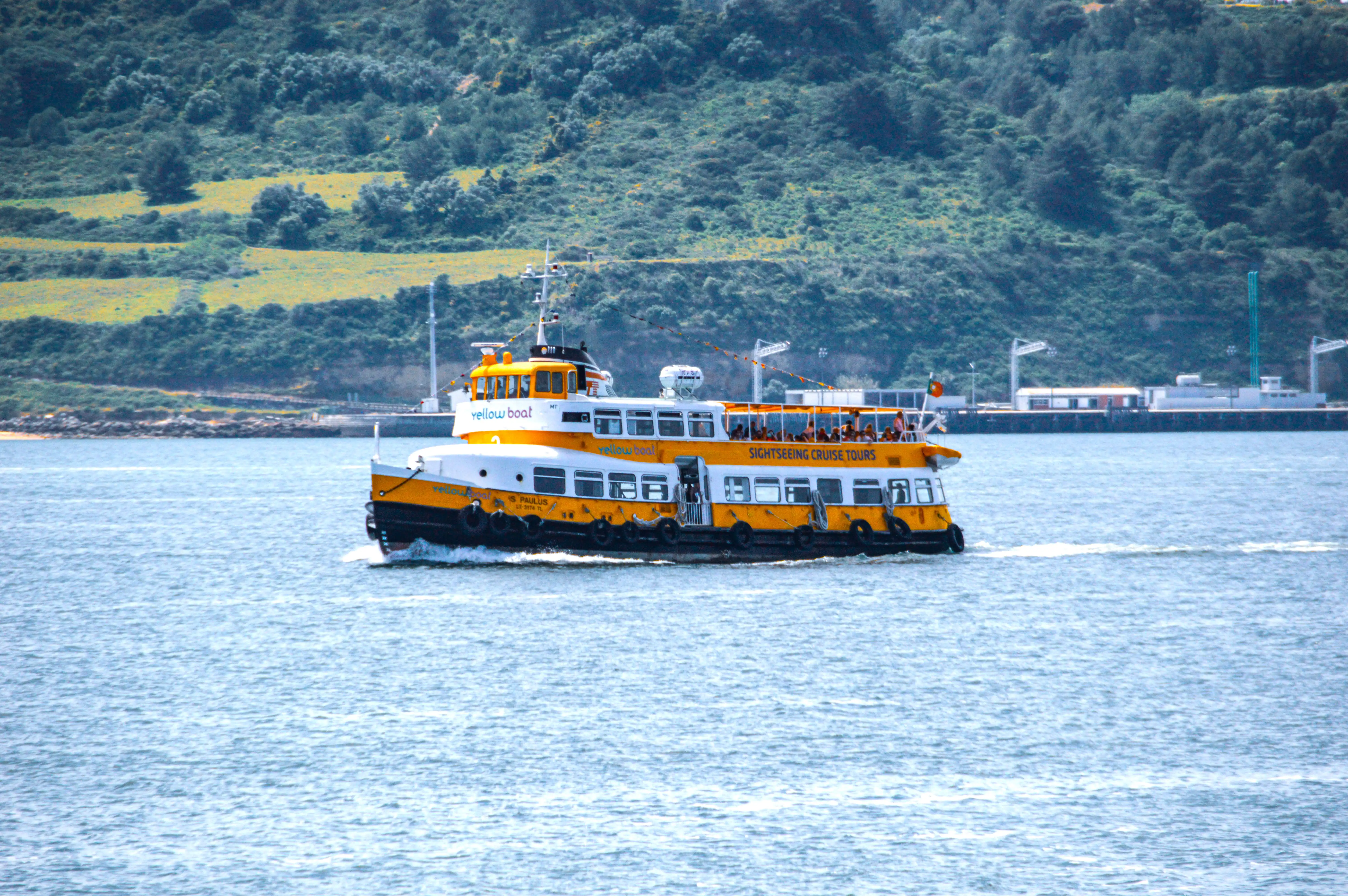 A yellow and white sightseeing boat named 